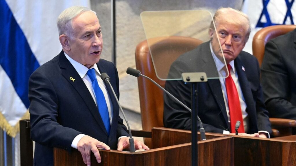 President Donald Trump listens to Israeli Prime Minister Benjamin Netanyahu as he addresses the Knesset, in Jerusalem on October 13, 2025. (Saul Loeb/Pool via Reuters)