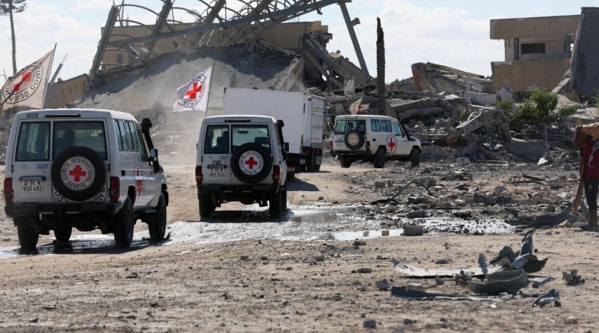 Red Cross vehicles escort a truck transporting the bodies of Palestinians who had been held in Israel during the war, amid a ceasefire between Israel and Hamas, in Khan Younis in the southern Gaza Strip, October 14, 2025 (Reuters/Ramadan Abed)