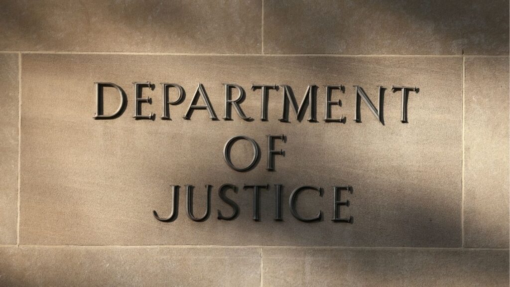 Shadows are cast on a sign at the Department of Justice building in Washington, D.C., U.S., September 23, 2025. (Reuters/Kevin Lamarque)
