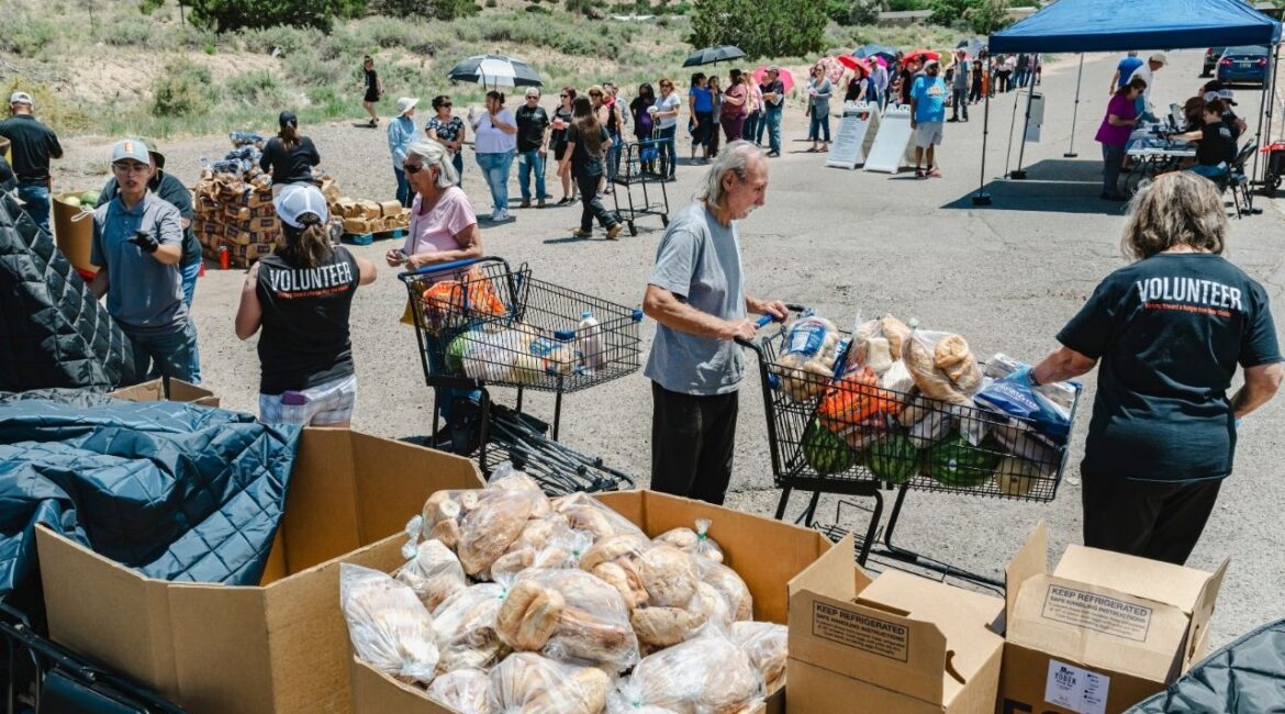 Staff and volunteers from The Food Depot distribute free provisions to needy families in Pojoaque, N.M., a rural community outside Santa Fe, on June 3, 2025. The federal Supplemental Nutritional Assistance Program will run out of money on Nov. 1. Some governors are shifting state money to cover part of the shortfall, bolster food pantries or both. (Meridith Kohut/The New York Times)