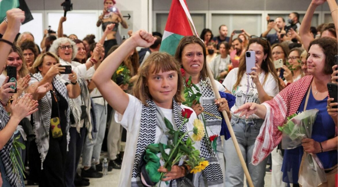 Swedish activist Greta Thunberg, who was part of the Global Sumud Flotilla seeking to deliver aid to Gaza and was detained by Israel, gestures as she is greeted by supporters upon her arrival to the Athens Eleftherios Venizelos International Airport, in Athens, Greece, October 6, 2025. Reuters/Louisa Gouliamaki)