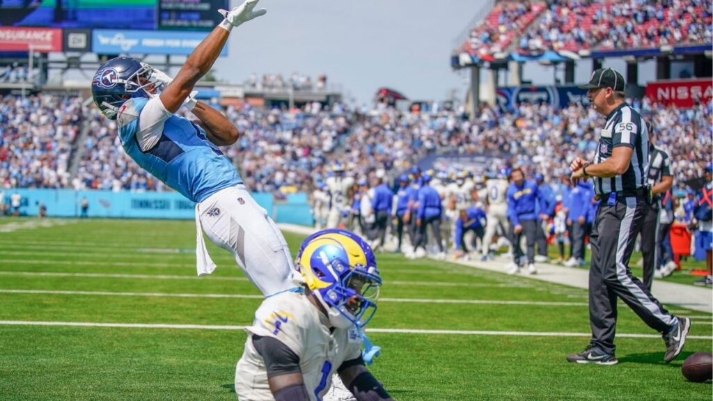 Tennessee Titans wide receiver Elic Ayomanor (5) celebrates his touchdown as Los Angeles Rams cornerback Emmanuel Forbes Jr. (1) sits dejected during the second quarter at Nissan Stadium in Nashville, Tenn., Sunday, Sept. 14, 2025. (USA Today Network via Reuters)