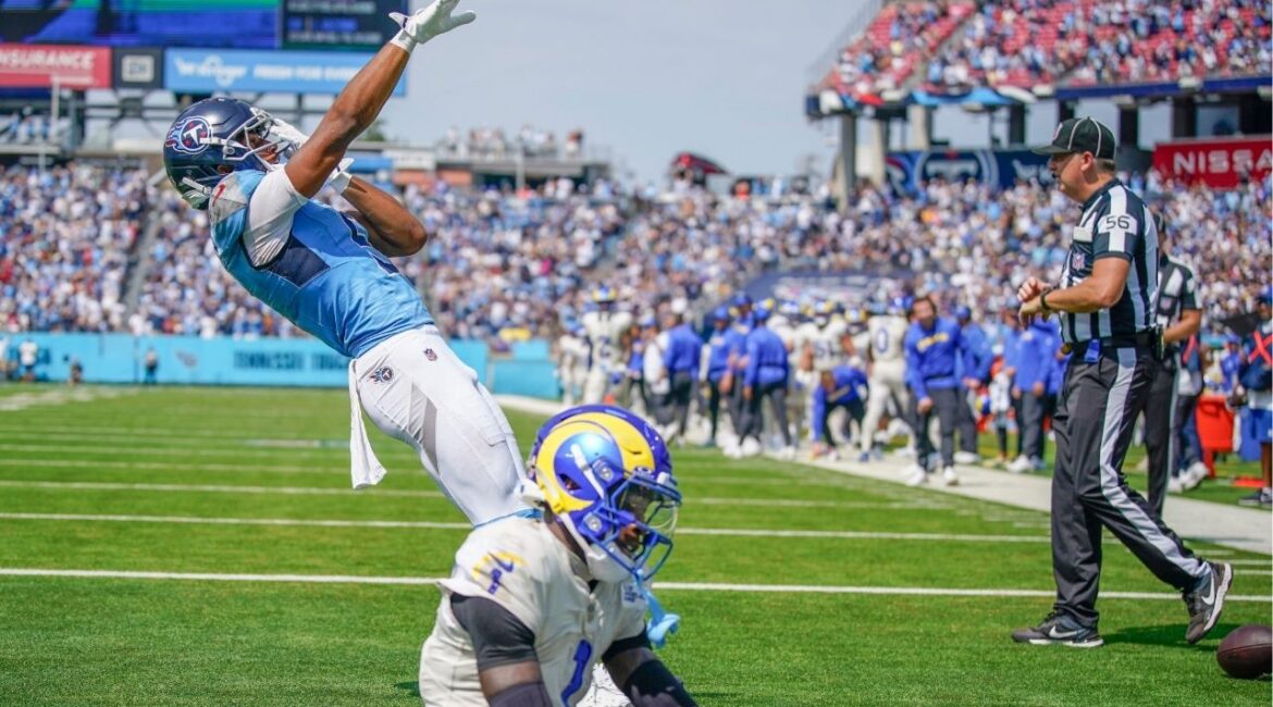 Tennessee Titans wide receiver Elic Ayomanor (5) celebrates his touchdown as Los Angeles Rams cornerback Emmanuel Forbes Jr. (1) sits dejected during the second quarter at Nissan Stadium in Nashville, Tenn., Sunday, Sept. 14, 2025. (USA Today Network via Reuters)