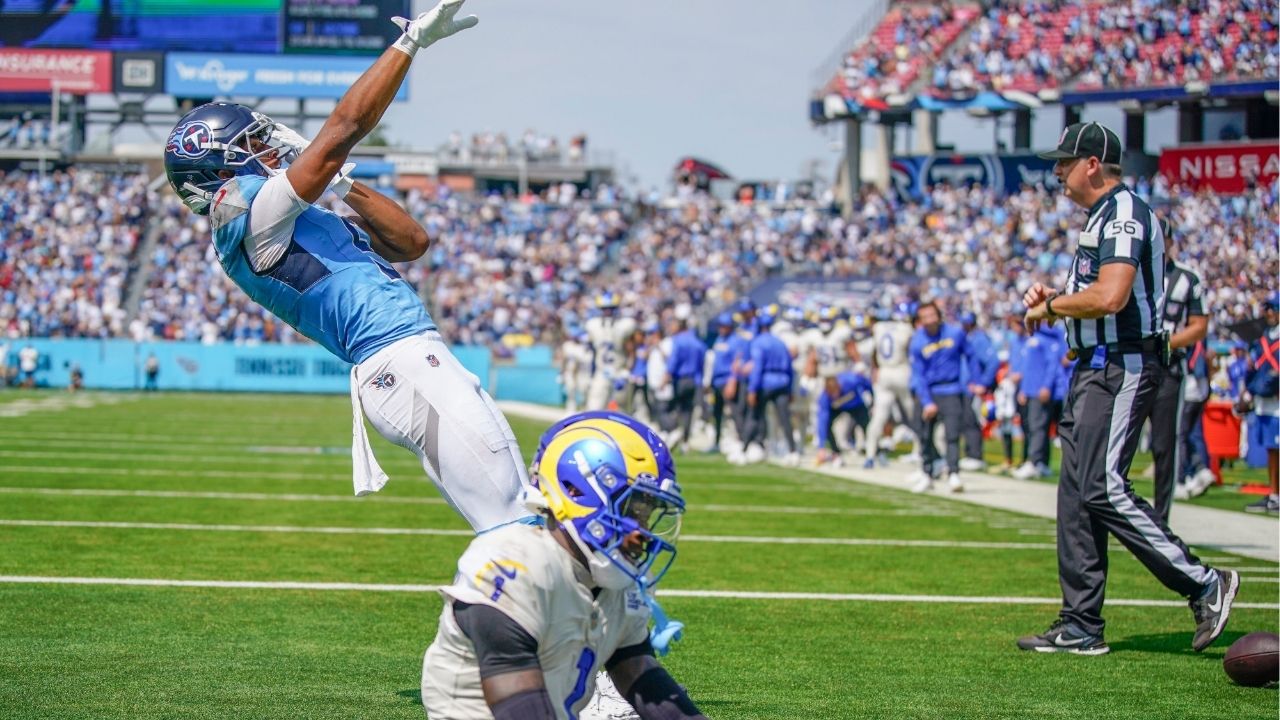 Tennessee Titans wide receiver Elic Ayomanor (5) celebrates his touchdown as Los Angeles Rams cornerback Emmanuel Forbes Jr. (1) sits dejected during the second quarter at Nissan Stadium in Nashville, Tenn., Sunday, Sept. 14, 2025. (USA Today Network via Reuters)