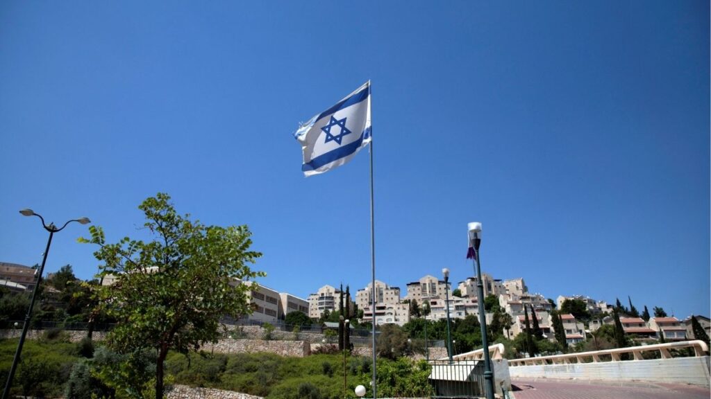 The Israeli national flag flutters as apartments are seen in the background in the Israeli settlement of Maale Adumim in the Israeli-occupied West Bank August 16, 2020. Picture taken August 16, 2020. (Reuters File)
