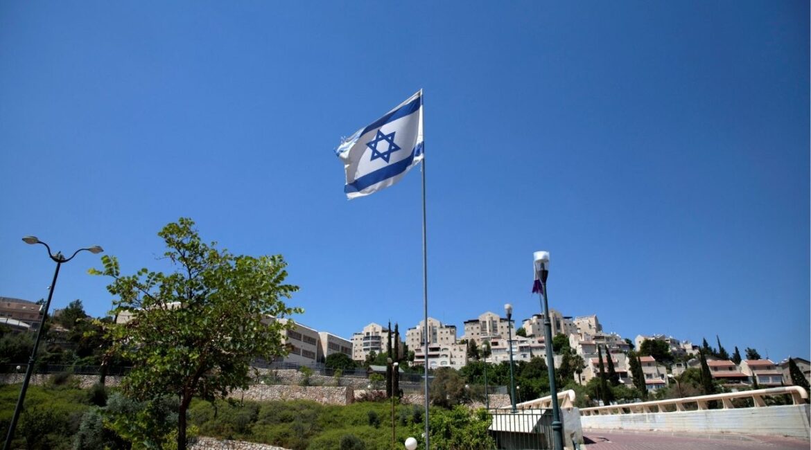 The Israeli national flag flutters as apartments are seen in the background in the Israeli settlement of Maale Adumim in the Israeli-occupied West Bank August 16, 2020. Picture taken August 16, 2020. (Reuters File)