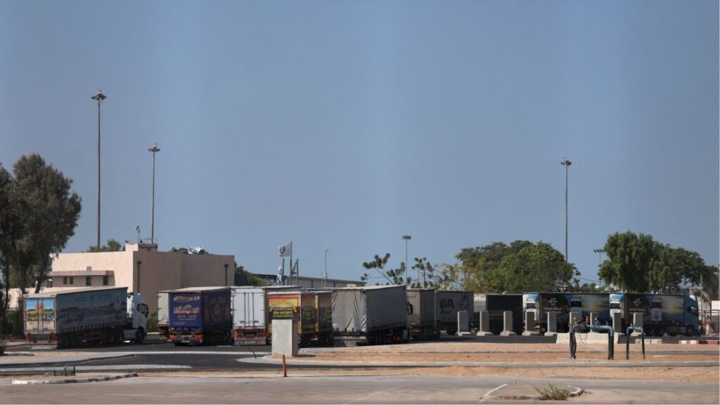 Trucks carrying aid wait at the Israeli side of the Kerem Shalom border crossing to southern Gaza, amid a ceasefire deal between Israel and Hamas, in southern Israel, October 16, 2025. (Reuters/Hannah McKay)