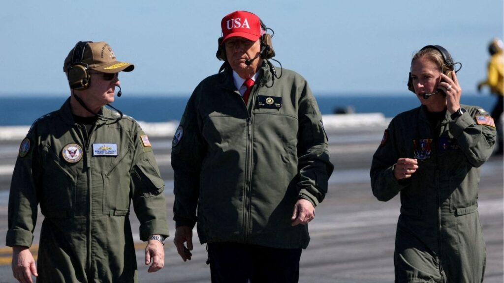 U.S. President Donald Trump walks with Chief of Naval Operations Admiral Daryl Caudle, aboard the aircraft carrier USS George H.W. Bush off the coast of Norfolk, Virginia, U.S. October 5, 2025. (Reuters/Jonathan Ernst)