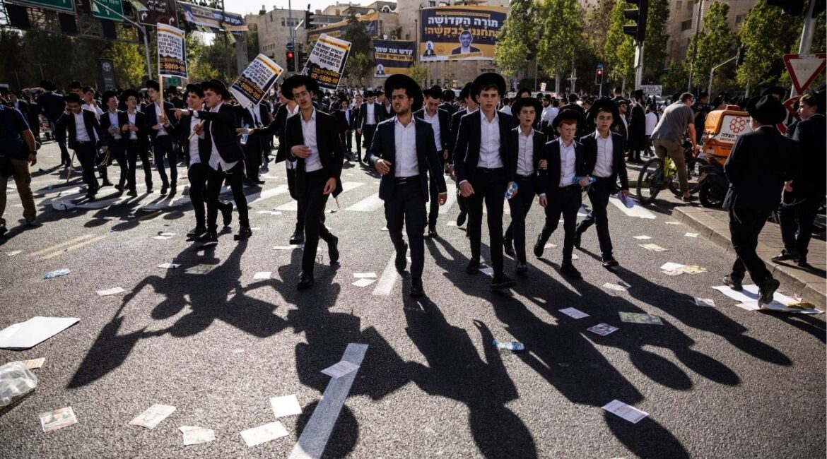 Ultra-Orthodox Jewish men gather for a demostration in Jerusalem to protest efforts to end a decades-old exemption from military service for most ultra-Orthodox seminary students on Thursday, Oct. 30, 2025. Tens of thousands of ultra-Orthodox Israelis are expected to gather in Jerusalem on Thursday for a mass demonstration against efforts to enlist some of them in the military, a protest that is likely to deepen divisions in a country reeling from two years of war. (David Guttenfelder/The New York Times)