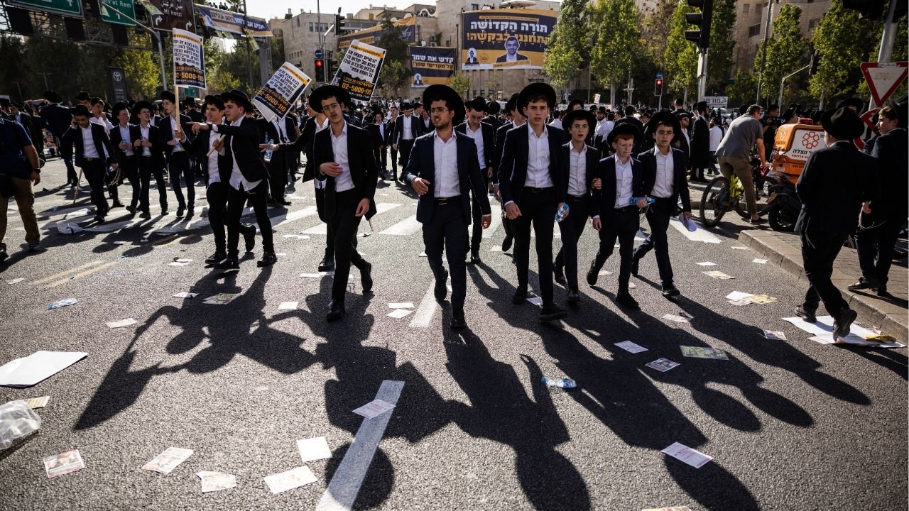 Ultra-Orthodox Jewish men gather for a demostration in Jerusalem to protest efforts to end a decades-old exemption from military service for most ultra-Orthodox seminary students on Thursday, Oct. 30, 2025. Tens of thousands of ultra-Orthodox Israelis are expected to gather in Jerusalem on Thursday for a mass demonstration against efforts to enlist some of them in the military, a protest that is likely to deepen divisions in a country reeling from two years of war. (David Guttenfelder/The New York Times)