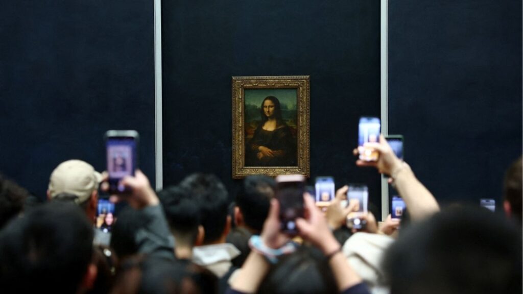 Visitors take pictures of the painting "Mona Lisa" (La Joconde) by Leonardo da Vinci at the Louvre Museum on the day it reopened to the public for the first time since last Sunday's heist, while the Galerie d'Apollon where eight pieces of Napoleon and the Empress's jewelry collection displayed in the gallery were stolen by thieves, remains closed, in Paris, France, October 22, 2025. (Reuters/Gonzalo Fuentes)