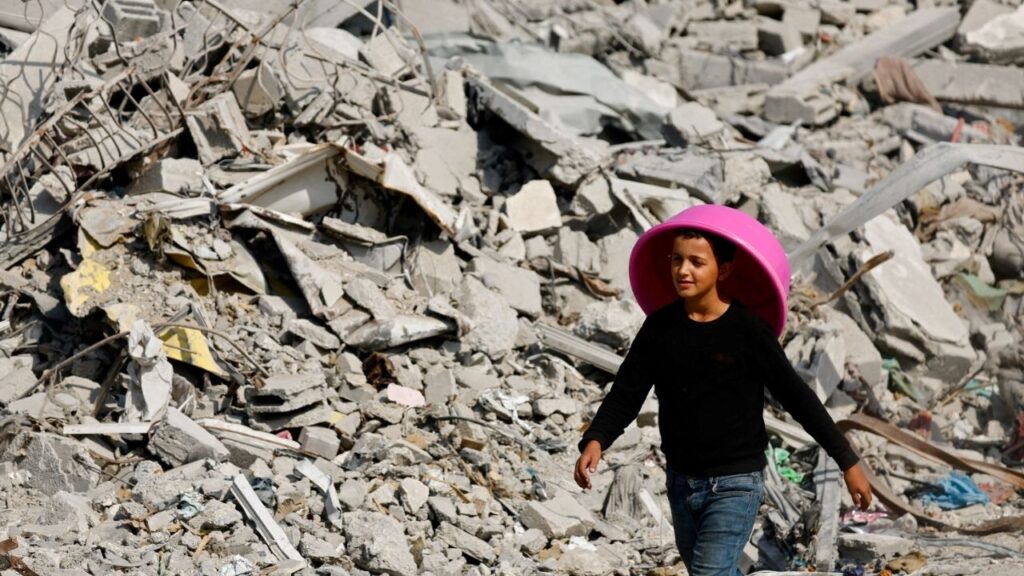 A Palestinian youth walks past the rubble of destroyed buildings, amid a ceasefire between Israel and Hamas, in Gaza City, November 2, 2025. (Reuters File)