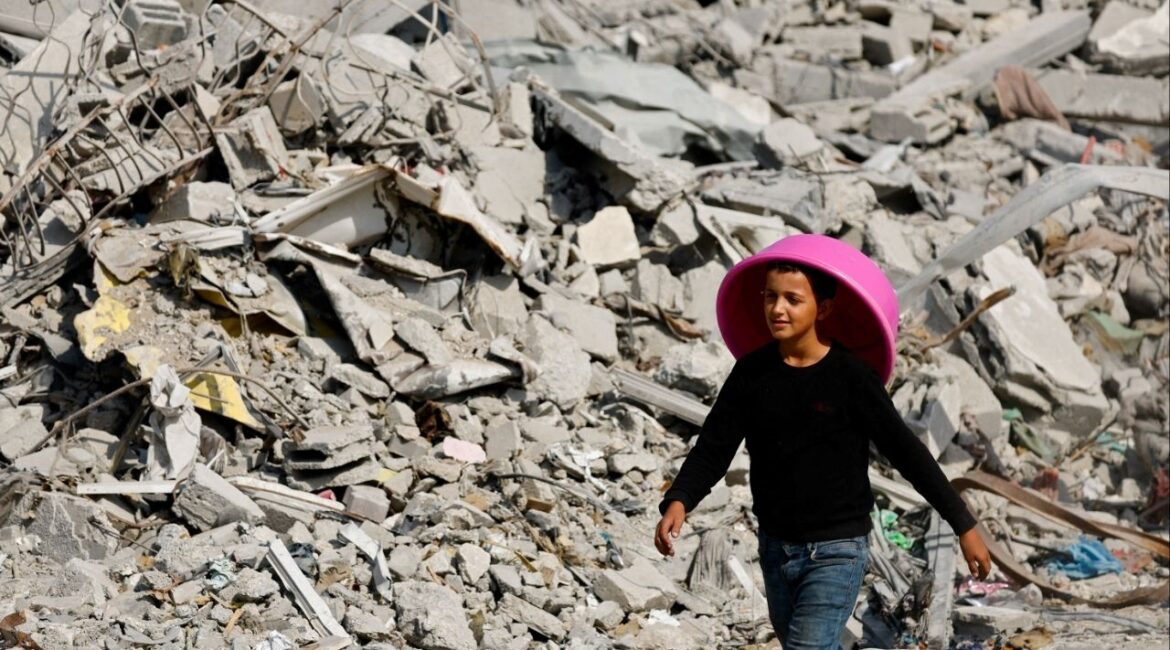 A Palestinian youth walks past the rubble of destroyed buildings, amid a ceasefire between Israel and Hamas, in Gaza City, November 2, 2025. (Reuters/Mahmoud Issa)