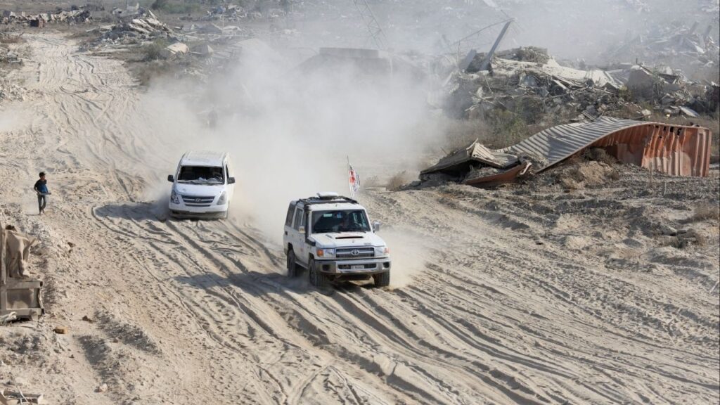 A Red Cross vehicle, escorted by a van driven by a Hamas militant, moves in an area within the so-called "yellow line" to which Israeli troops withdrew under the ceasefire, as Hamas says it continues to search for the bodies of deceased hostages seized during the October 7, 2023, attack on Israel, in Gaza City November 12, 2025. (Reuters/Dawoud Abu Alk)