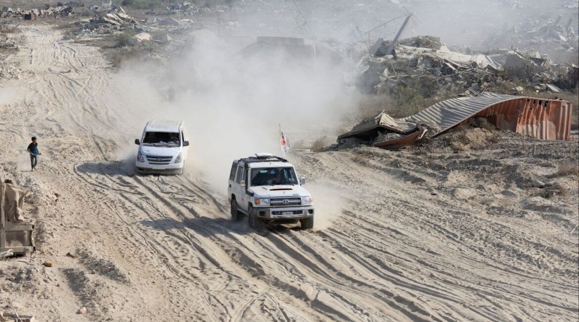 A Red Cross vehicle, escorted by a van driven by a Hamas militant, moves in an area within the so-called "yellow line" to which Israeli troops withdrew under the ceasefire, as Hamas says it continues to search for the bodies of deceased hostages seized during the October 7, 2023, attack on Israel, in Gaza City November 12, 2025. (Reuters/Dawoud Abu Alk)