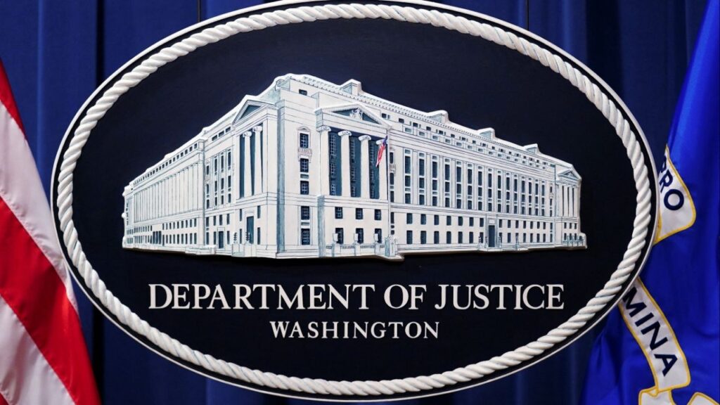 A U.S. Justice Department logo or seal showing Justice Department headquarters, known as "Main Justice," is seen behind the podium in the Department's headquarters briefing room before a news conference with the Attorney General in Washington, January 24, 2023. (Reuters/Kevin Lamarque)