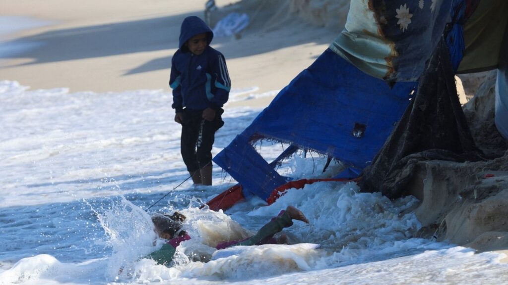 A child falls into the sea as Palestinians shelter in tents during a ceasefire between Israel and Hamas, in Khan Younis, southern Gaza Strip, November 15, 2025. (Reuters/Ramadan Abed)
