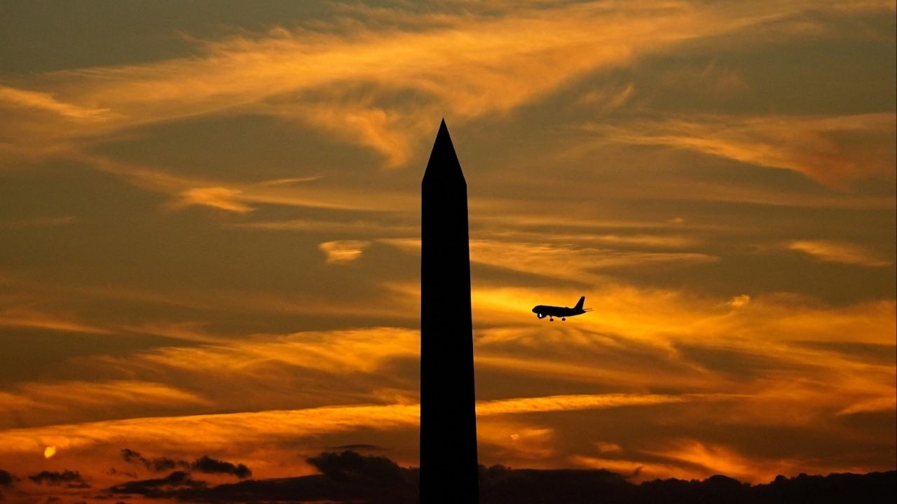 A commercial aircraft flies past the Washington Monument during a partial government shutdown in Washington, D.C., U.S., October 2, 2025. (Reuters/Nathan Howard)