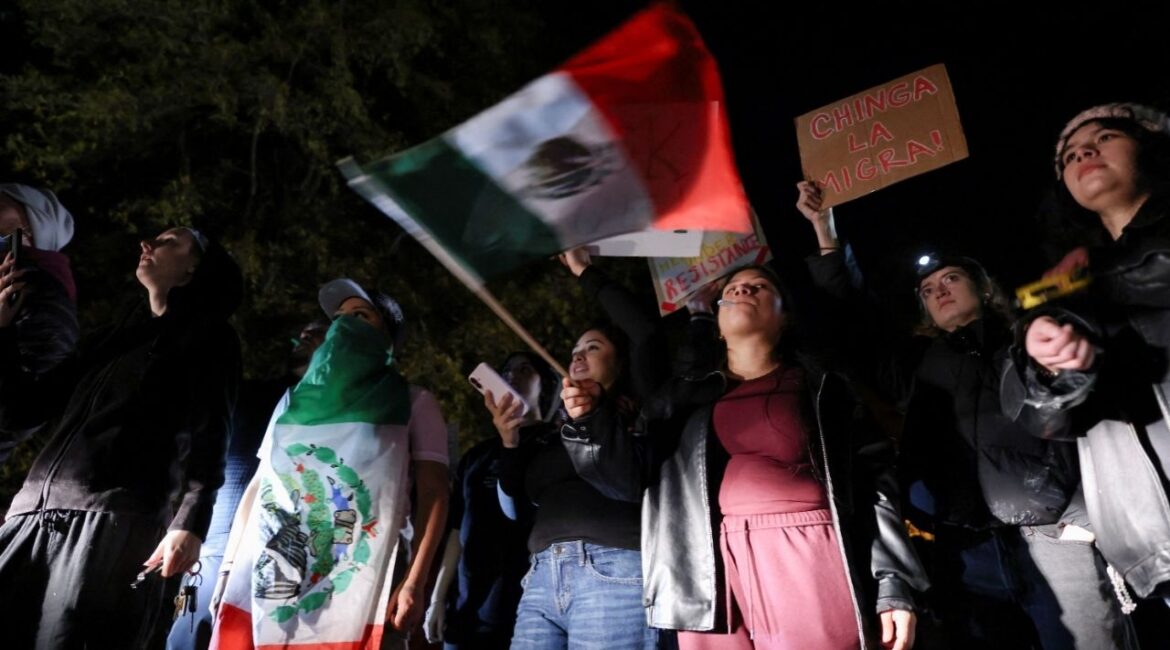 A demonstrator waves a Mexican flag during a protest outside the Department of Homeland Security office, after federal authorities conducted raids, expanding their crackdown on illegal immigration, in Charlotte, North Carolina, U.S. November 16, 2025. (Reuters/Sam Wolfe)
