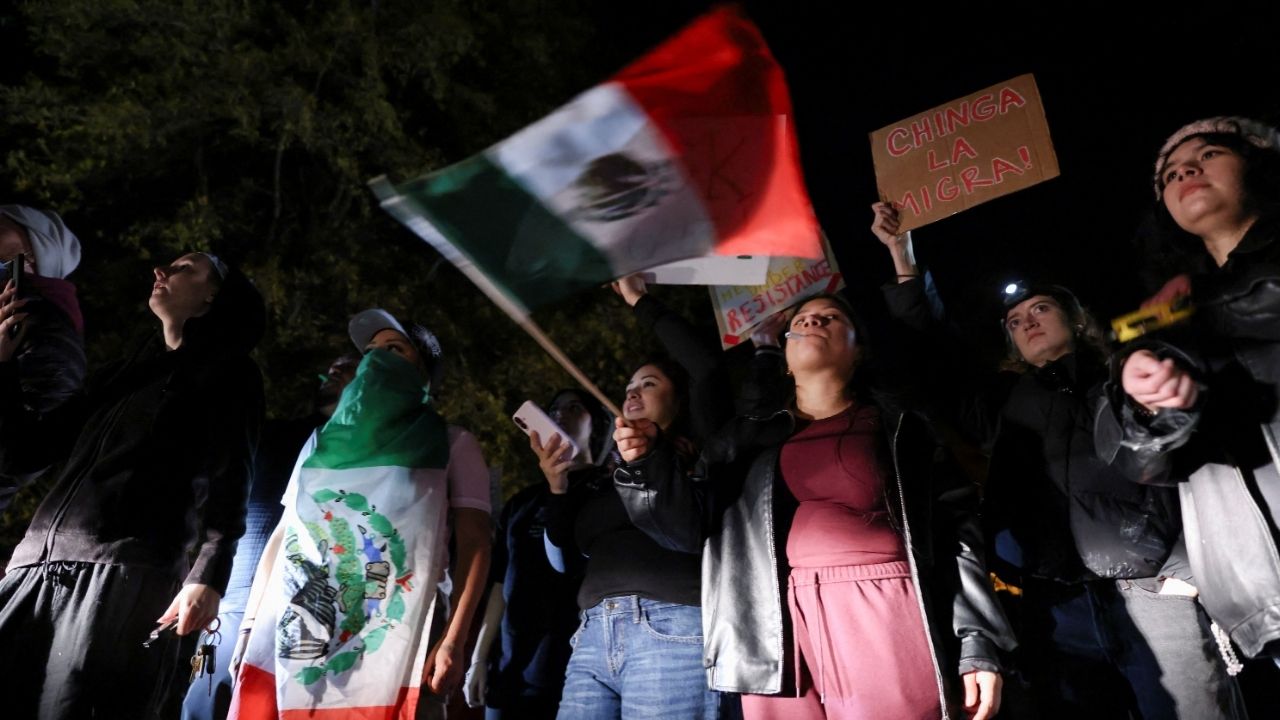 A demonstrator waves a Mexican flag during a protest outside the Department of Homeland Security office, after federal authorities conducted raids, expanding their crackdown on illegal immigration, in Charlotte, North Carolina, U.S. November 16, 2025. (Reuters/Sam Wolfe)