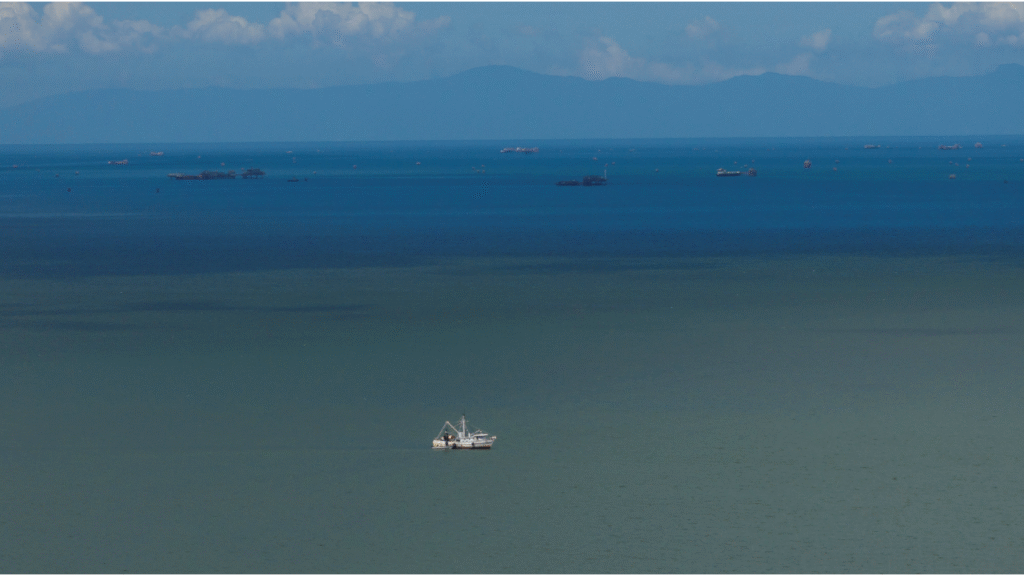 A drone view shows a fishing boat anchored in the Gulf of Paria, and the coast of Venezuela in the back, in Cedros, Trinidad and Tobago, November 17, 2025. (Reuters/Marco Bello)