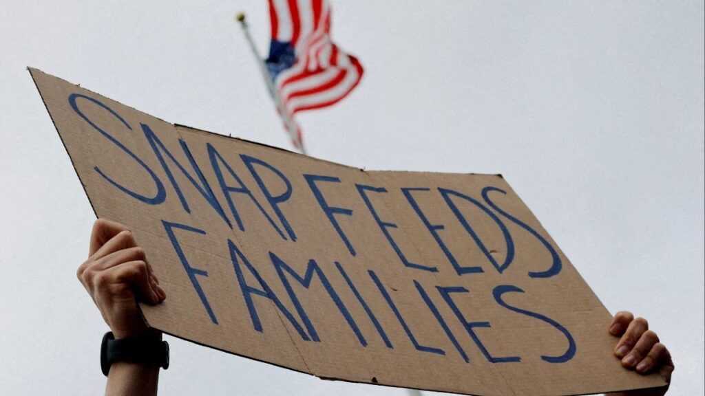 A man holds a sign reading "SNAP Feeds Families," as food aid benefits will be suspended starting November 1 amid the ongoing U.S. government shutdown, during "A Rally for SNAP" on the steps of the Massachusetts Statehouse in Boston, Massachusetts, U.S., October 28, 2025. (Reuters File)