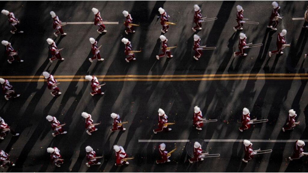 A marching band moves along the route of the annual Macy’s Thanksgiving Day Parade in Manhattan, on Thursday morning, Nov. 27, 2025. (Vincent Alban/The New York Times)