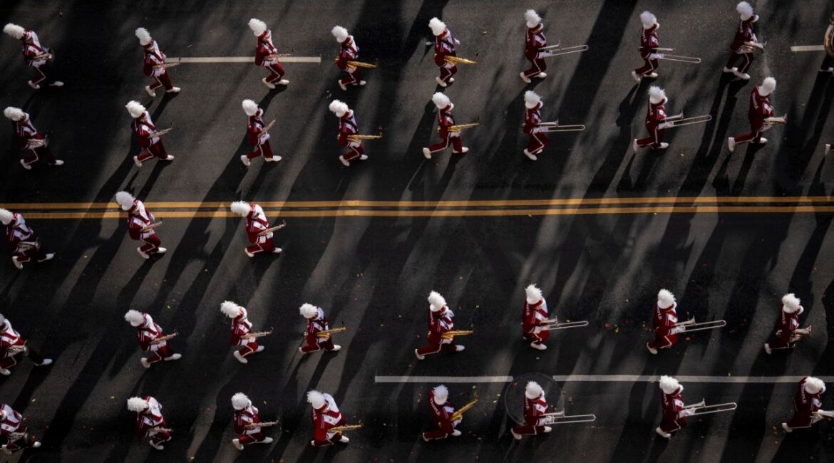 A marching band moves along the route of the annual Macy’s Thanksgiving Day Parade in Manhattan, on Thursday morning, Nov. 27, 2025. (Vincent Alban/The New York Times)