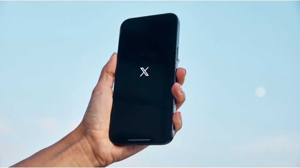 A phone displaying the X logo, Aug. 3, 2025. X launched a feature over the weekend that displays users’ locations, renewing scrutiny of the provenance of many accounts, including those that post frequently about American politics. (Andres Kudacki/The New York Times)