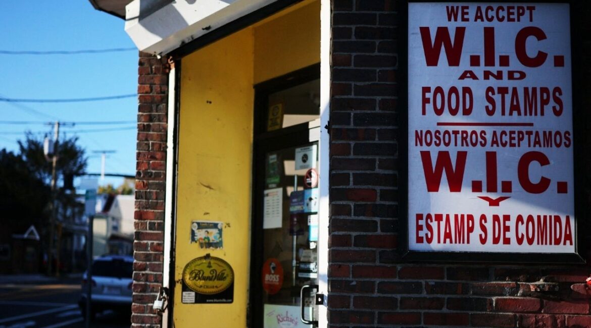 A sign advertises that WIC and Food Stamps are accepted at a convenience store, as tens of millions of Americans might not receive food stamps and other food aid in November because of the government shutdown, in Chelsea, Massachusetts, U.S., October 24, 2025. (Reuters/Brian Snyder)