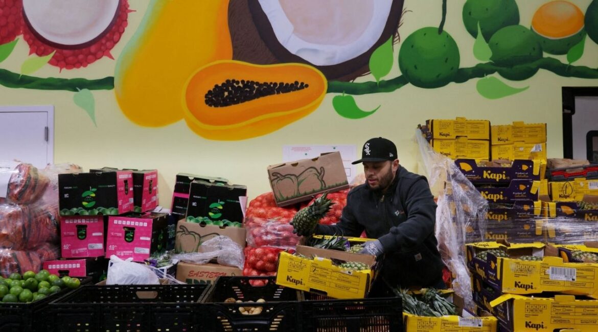 A worker sorts fresh fruit and vegetables at La Colaborativa's food pantry, as food aid benefits, in Chelsea, Massachusetts, U.S., October 29, 2025. (Reuters File)