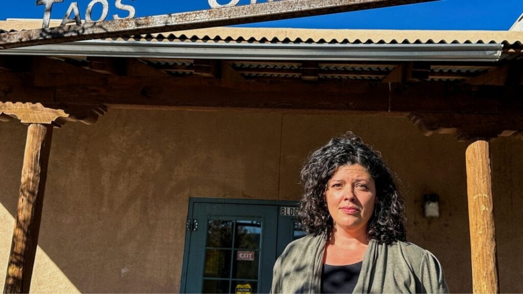 Allyson O'Brien, a special education teacher who stands to save about $12,000 a year in child care costs starting Nov. 1, when New Mexico becomes the first U.S. state to offer free universal child care, poses for a photograph outside of the Taos Charter School, in Taos, New Mexico, U.S., Oct. 30, 2025. (Reuters/Andrew Hay)