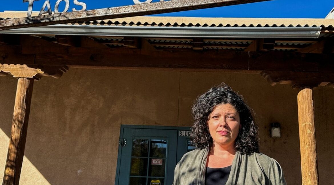 Allyson O'Brien, a special education teacher who stands to save about $12,000 a year in child care costs starting Nov. 1, when New Mexico becomes the first U.S. state to offer free universal child care, poses for a photograph outside of the Taos Charter School, in Taos, New Mexico, U.S., Oct. 30, 2025. (Reuters/Andrew Hay)