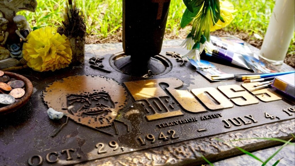 Asset id: 2035052009 Gotha, Florida -2021: Grave of Bob Ross. Robert Norman Ross was an American painter, art instructor and television host. He was the creator and host of "The Joy of Painting." Happy Little Trees.
