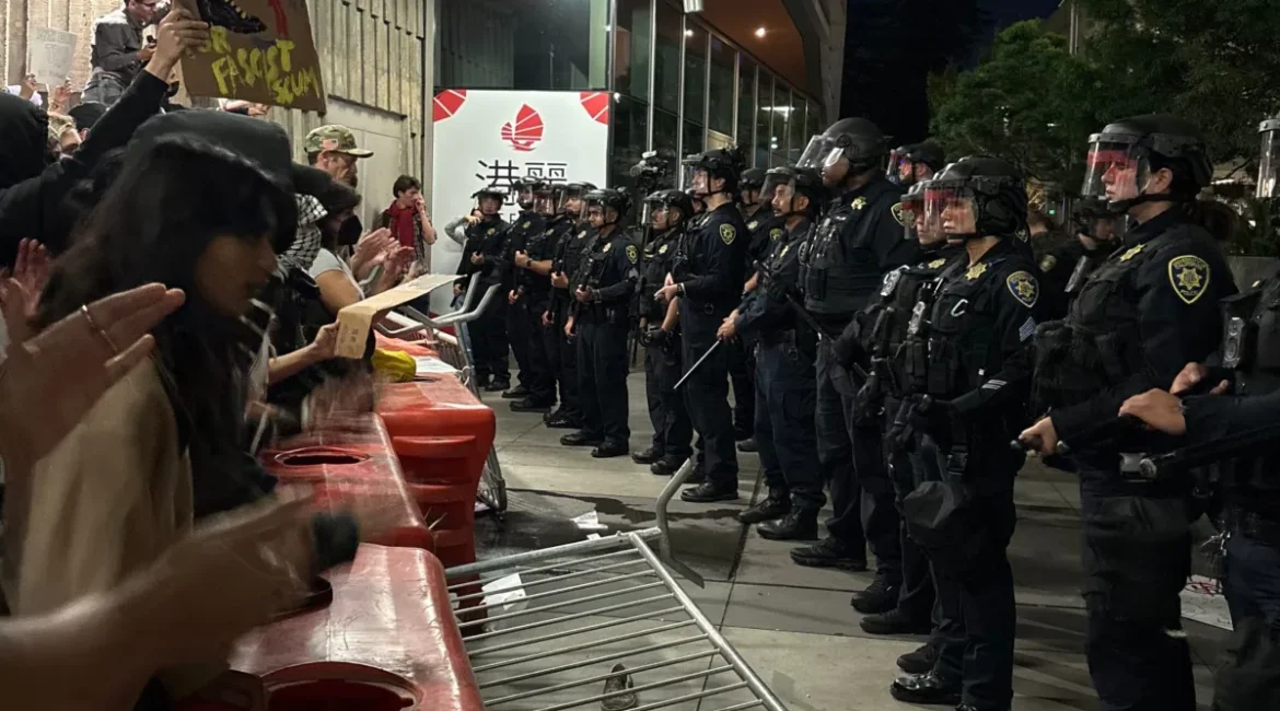 Image of protesters and police squared off at Turning Point USA appearance at UC Berkeley
