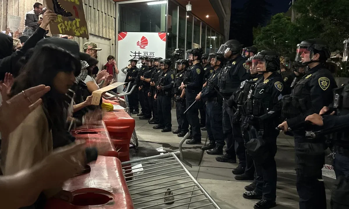 Image of protesters and police squared off at Turning Point USA appearance at UC Berkeley