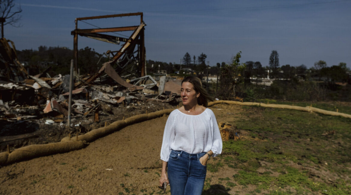 Maggie Neilson, whose home insurer elected not to renew her coverage months before the fires, visits the ruins of her 1924-built home in the Pacific Palisades neighborhood of Los Angeles on April 24, 2025. The only insurer Neilson could find was the state FAIR plan, which charged her about 40% more, for about 40% less coverage. She now expects to receive $1.5 million for a rebuild that is likely to cost around $3 million. (Mark Abramson/The New York Times)