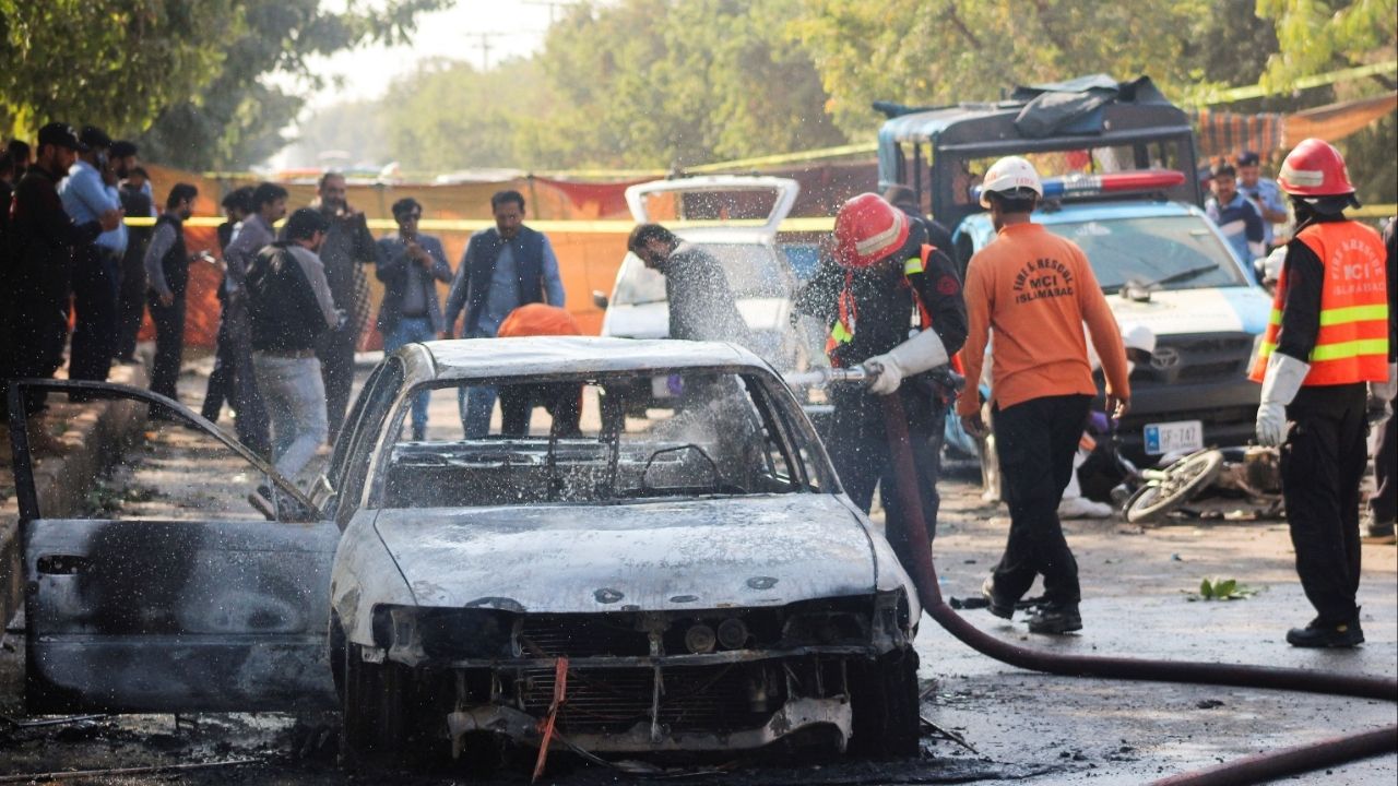 Firefighter douses a vehicle after a blast outside a court building in Islamabad, Pakistan November 11, 2025. (Reuters/Stringer)