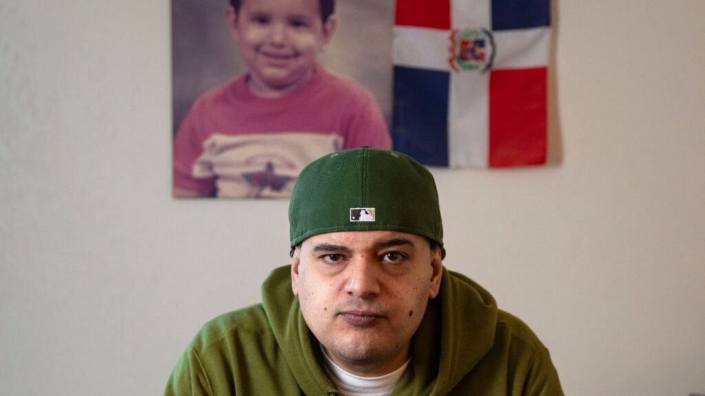 Gustavo Rojas, 42, a citizen who came to the United States from the Dominican Republic in 1990, in Roslindale, Mass. on Nov. 4, 2025. Large majorities of immigrants say their own future remains bright. “Trump is trying to make this country more valuable instead of bringing anybody that wants to come in and do whatever they want,” said Rojas, who is unemployed and identifies as a Republican. (Ann Hermes/The New York Times)