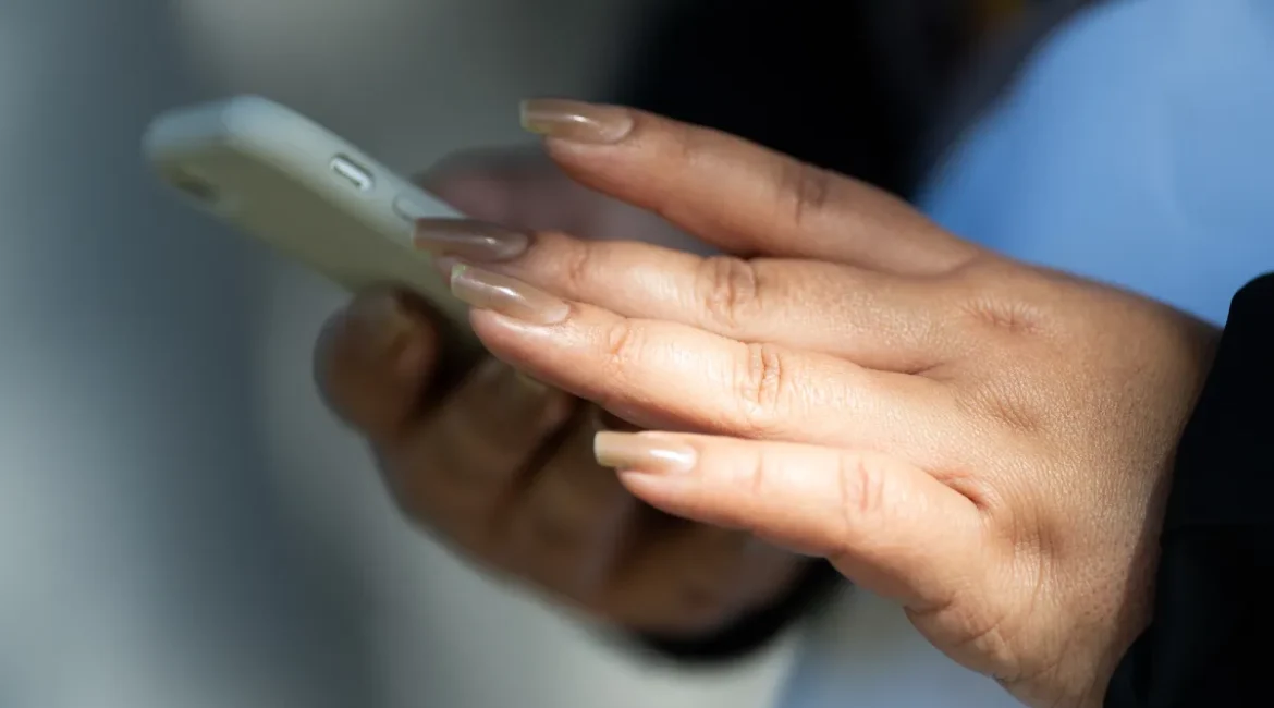 Image of a person browsing the internet with a cellphone in their hands