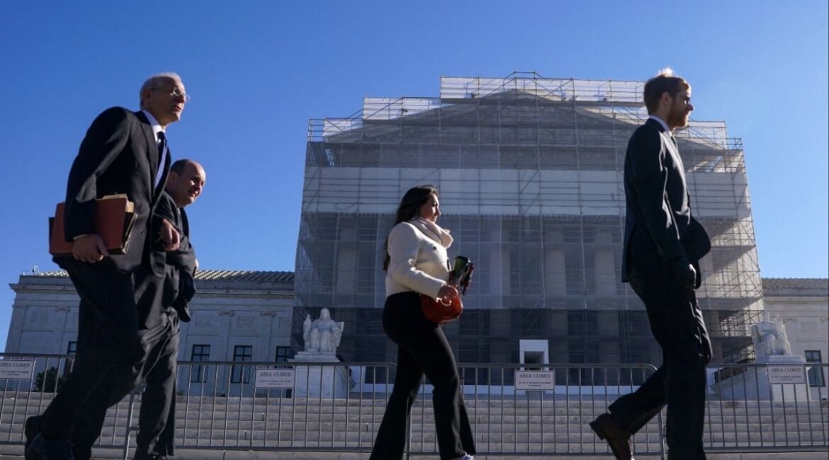 Members of the public walk outside the U.S. Supreme Court to attend oral arguments on U.S. President Donald Trump's bid to preserve sweeping tariffs after lower courts ruled that Trump overstepped his authority, in Washington, D.C., U.S., November 5, 2025. (Reuters/Nathan Howard)