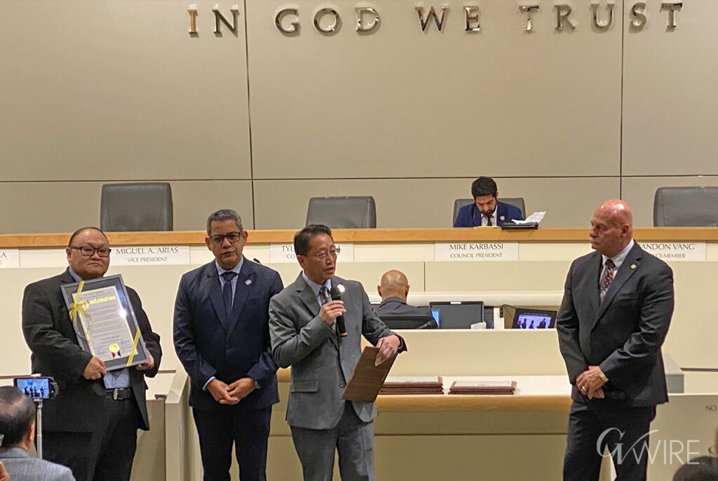 Neng Chu Vang receives a proclamation from Fresno City Councilmembers Miguel Arias, Brandon Vang, and Mayor Jerry Dyer.