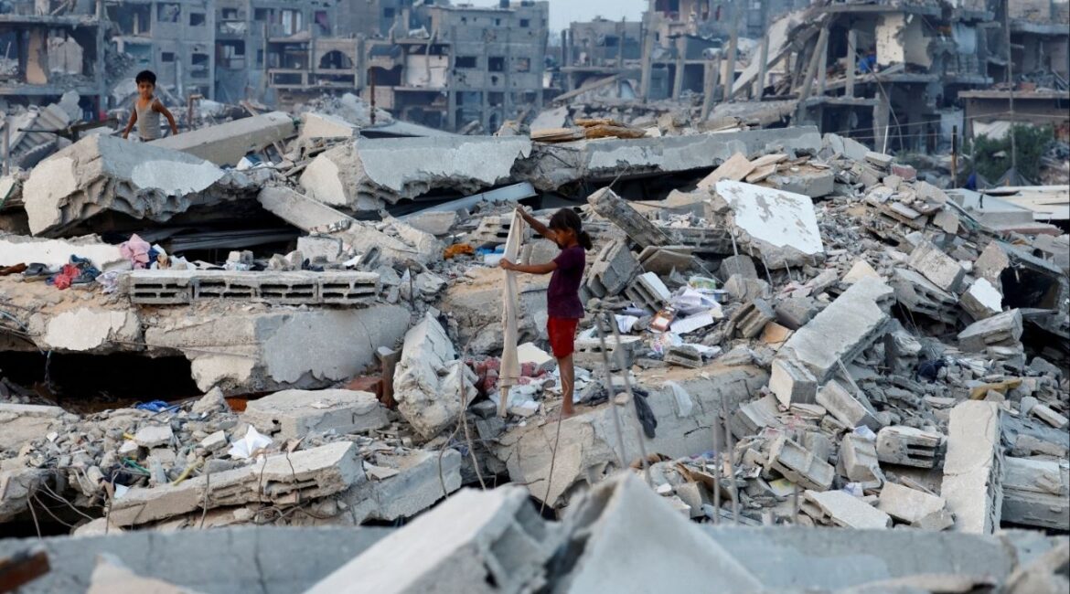 Palestinian children stand on the rubble of destroyed buildings, amid a ceasefire between Israel and Hamas, in Jabalia, northern Gaza Strip, November 6, 2025. (Reuters/Mahmoud Issa)