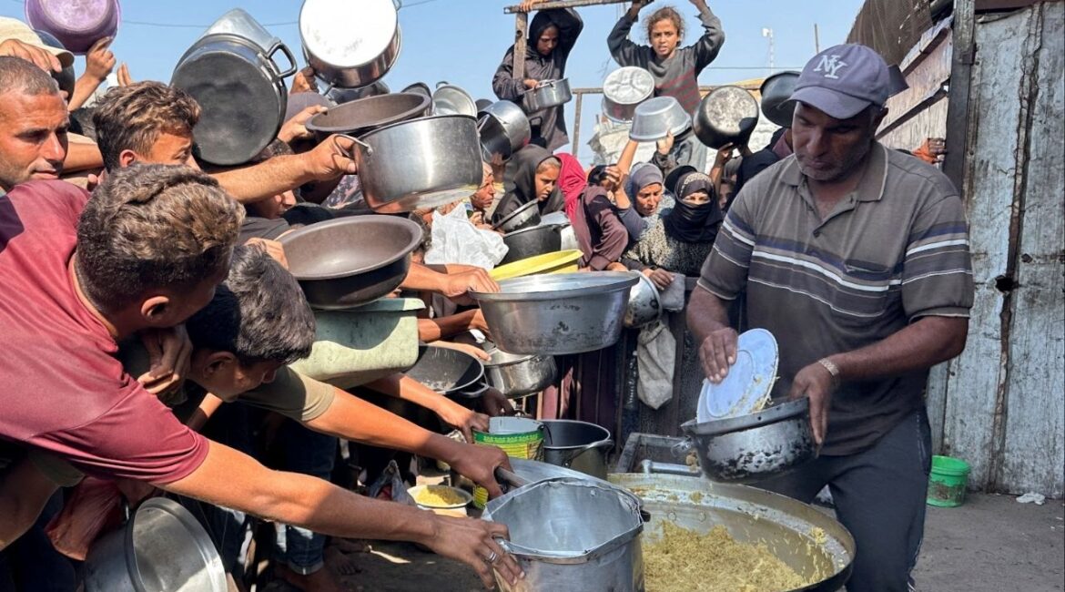 Palestinians gather to receive food from a charity kitchen amid a ceasefire between Israel and Hamas, in Khan Younis in the southern Gaza Strip, November 5, 2025. (Reuters/Haseeb Alwazeer)