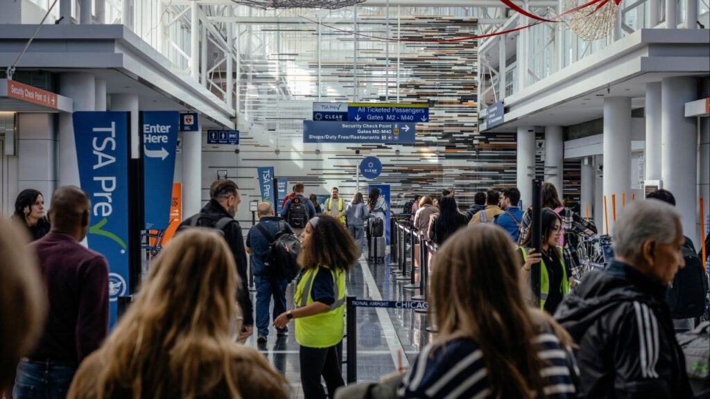 Passengers enter a security checkpoint at Chicago O’Hare International Airport in Chicago, on Friday, Nov. 7, 2025. Even if the government ends the flight restrictions in place at 40 busy airports that contributed to widespread disruptions over the weekend, it will take days for airlines to recover. (Jamie Kelter Davis/The New York Times)