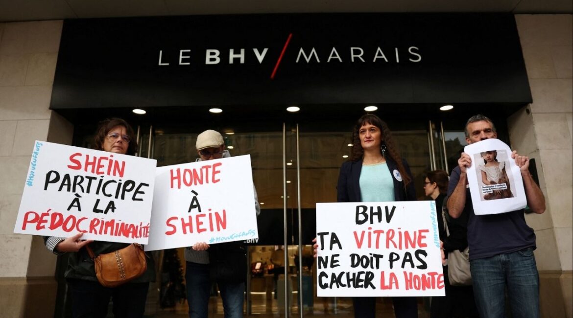 People protest against the sale of child-like sex dolls by Chinese fast-fashion retailer Shein during a demonstration in front of the Bazar de l'Hotel de Ville, Le BHV Marais department store, ahead of the opening of Shein's fast fashion first permanent shop in Paris, France, November 3, 2025. The slogans on placards read "Shame on Shein!", "Shein is complicit in child pornography" and "BHV, your shop window shouldn't hide this shame". (Reuters/Abdul Saboor)