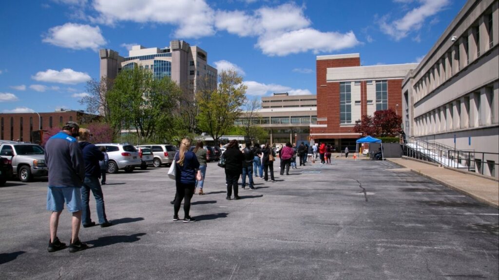 People wait in a line outside a newly reopened career center for in-person appointments in Louisville, Kentucky, U.S., April 15, 2021. (Reuters/Amira Karaoud)