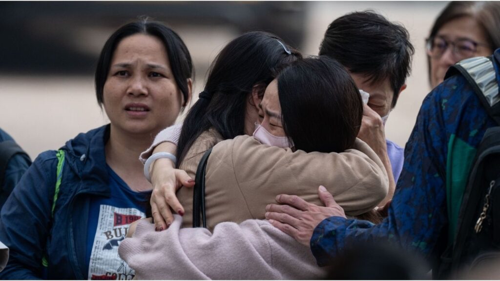 People with missing family members react after checking photographs of the deceased in Tai Po, Hong Kong, Nov. 27, 2025. Authorities said flammable netting and foam boards may have fueled the city’s deadliest blaze in nearly 70 years. (Lam Yik Fei/The New York Times)