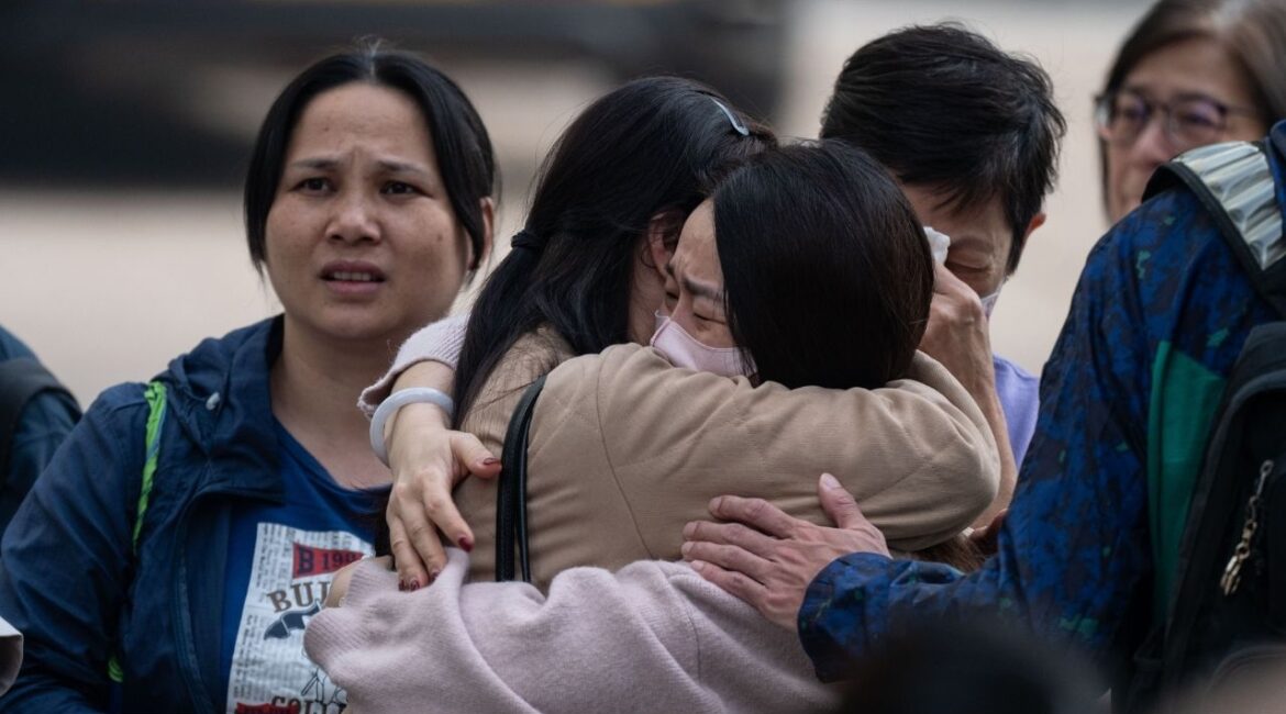 People with missing family members react after checking photographs of the deceased in Tai Po, Hong Kong, Nov. 27, 2025. Authorities said flammable netting and foam boards may have fueled the city’s deadliest blaze in nearly 70 years. (Lam Yik Fei/The New York Times)