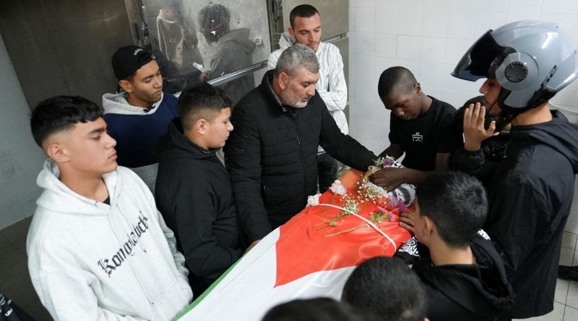 Relatives of one of two Palestinians, who were killed in an Israeli raid, react near their body ahead of their funeral, at a hospital in Ramallah, in the Israeli-occupied West Bank November 21, 2025. (Reuters/Ismael Khader)